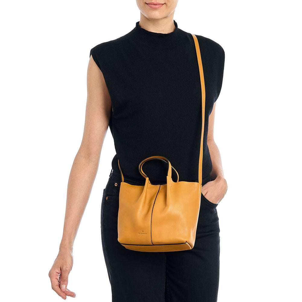 Nina | Women's crossbody bag in leather color yellow narciso — 
lifestyle view
 — 2 of 5